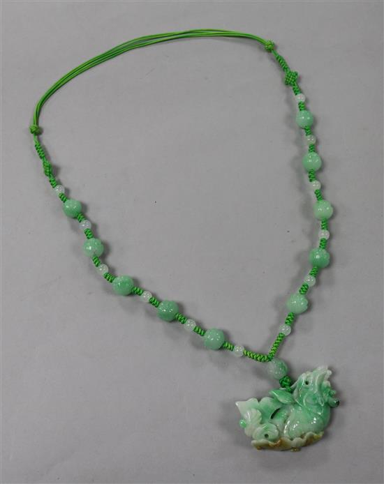 A carved jade pendant on a hardstone bead and rope necklace, pendant 50mm.